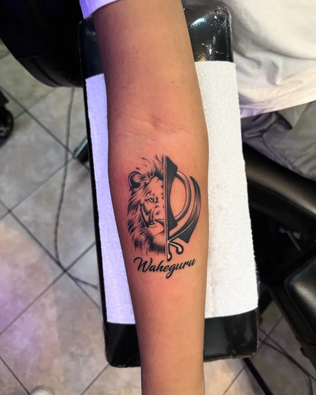 Symmetrical split realism portrait of a lion and Khanda symbol