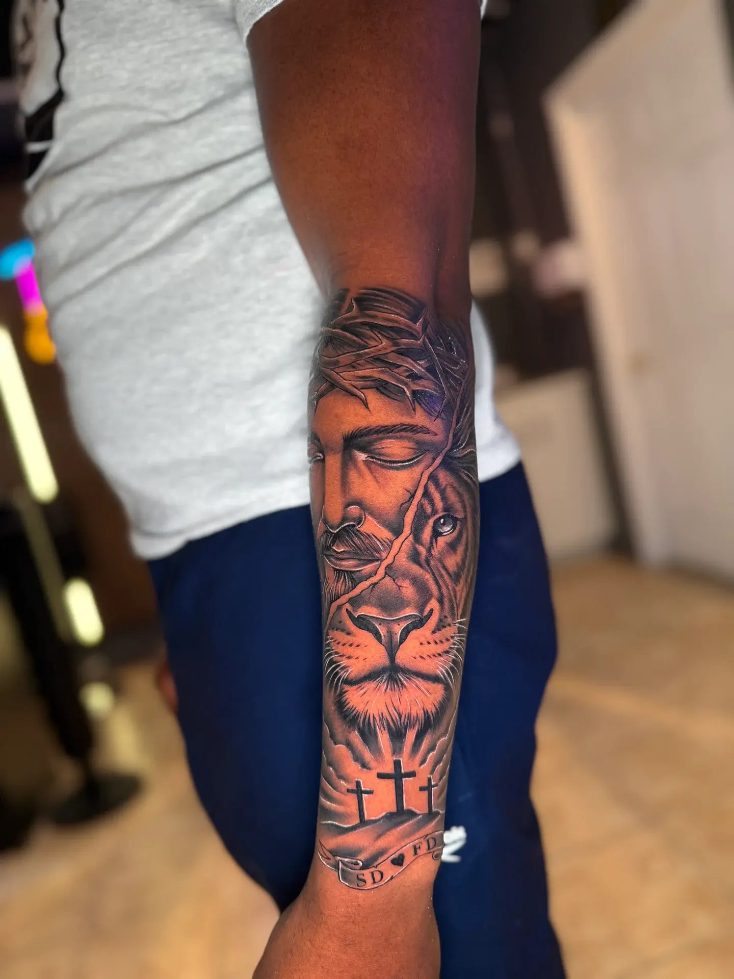 Hyper-realistic black and grey split portrait of Jesus and lion